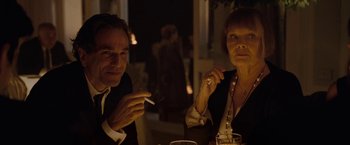Movie still from “Nine” (2009), directed by Rob Marshall – A man and a woman sitting at a dinner table; Close Up shot, Over the shoulder angle