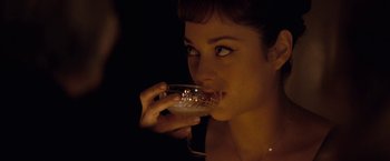 Movie still from “Nine” (2009), directed by Rob Marshall – A beautiful woman holding a drink in her hand; Close Up shot, Over the shoulder angle