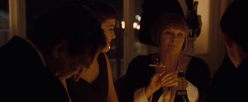 Movie still from “Nine” (2009), directed by Rob Marshall – A woman smoking a cigarette while talking to another woman; Close Up shot, Over the shoulder angle