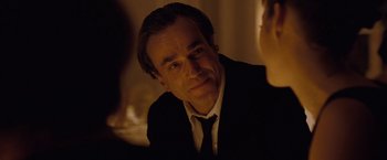 Movie still from “Nine” (2009), directed by Rob Marshall – A person wearing a suit and tie; Close Up shot, Over the shoulder angle