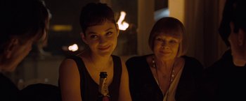 Movie still from “Nine” (2009), directed by Rob Marshall – A woman standing next to another woman in a dark room; Close Up shot, Over the shoulder angle