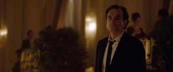 Movie still from “Nine” (2009), directed by Rob Marshall – A man wearing a suit and tie standing in a room; Close Up shot, Low angle