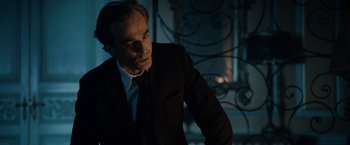 Movie still from “Nine” (2009), directed by Rob Marshall – A man wearing a suit and tie standing in a room; Medium shot, Low angle