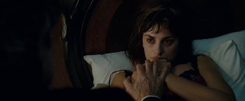 Movie still from “Nine” (2009), directed by Rob Marshall – A woman laying in a bed with her hand over her mouth; Close Up shot, High angle