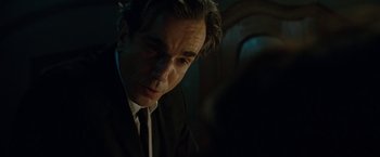 Movie still from “Nine” (2009), directed by Rob Marshall – A person wearing a suit and tie; Close Up shot, Over the shoulder angle