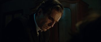 Movie still from “Nine” (2009), directed by Rob Marshall – A person wearing a suit and tie; Close Up shot, Low angle