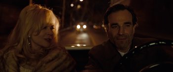 Movie still from “Nine” (2009), directed by Rob Marshall – A man and a woman sitting in the back of a car at night; Close Up shot, Low angle