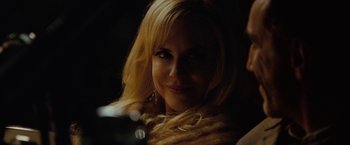 Movie still from “Nine” (2009), directed by Rob Marshall – A woman with blonde hair and a smile; Close Up shot, Over the shoulder angle