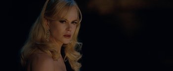 Movie still from “Nine” (2009), directed by Rob Marshall – A beautiful woman with blonde hair wearing a black top; Close Up shot, Over the shoulder angle