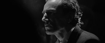 Movie still from “Nine” (2009), directed by Rob Marshall – Black and white photograph of a man in a suit looking to his left; Close Up shot, Low angle