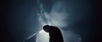 Movie still from “Nine” (2009), directed by Rob Marshall – A man standing in front of an image of a woman; Close Up shot, Over the shoulder angle