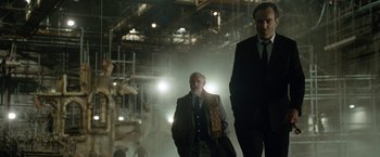 Movie still from “Nine” (2009), directed by Rob Marshall – Two men in suits and ties walking in a building; Wide shot, Low angle