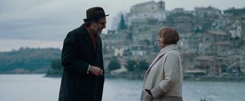 Movie still from “Nine” (2009), directed by Rob Marshall – A man and a woman standing next to each other near a body of water; Medium shot, Over the shoulder angle