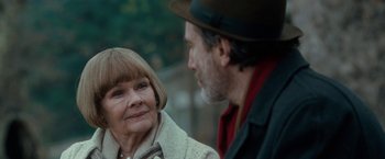 Movie still from “Nine” (2009), directed by Rob Marshall – An older woman and an older man are talking to each other; Close Up shot, Over the shoulder angle