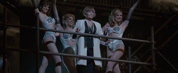 Movie still from “Nine” (2009), directed by Rob Marshall – A woman standing next to two other women in lingerie; Medium shot, Low angle