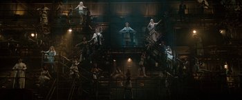 Movie still from “Nine” (2009), directed by Rob Marshall – A group of people standing on top of stairs; Extreme Wide shot, Overhead angle