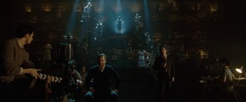 Movie still from “Nine” (2009), directed by Rob Marshall – A group of people sitting in a dark room; Wide shot, High angle