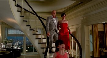 Movie still from “Nine Lives” (2016), directed by Barry Sonnenfeld – A man and a woman and a child standing on a staircase; Wide shot, Low angle