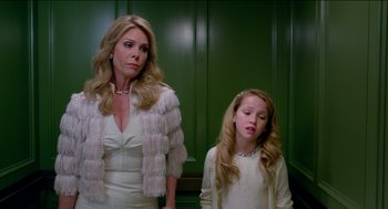 Movie still from “Nine Lives” (2016), directed by Barry Sonnenfeld – A woman standing next to a young girl in a white dress; Medium shot, Low angle