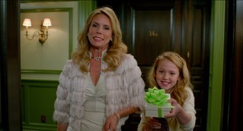 Movie still from “Nine Lives” (2016), directed by Barry Sonnenfeld – A woman and a young girl holding a present; Medium shot, Over the shoulder angle