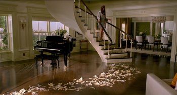 Movie still from “Nine Lives” (2016), directed by Barry Sonnenfeld – A woman walking down the stairs of a house; Wide shot, High angle