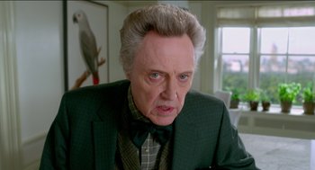 Movie still from “Nine Lives” (2016), directed by Barry Sonnenfeld – An older man in a green jacket and a bow tie; Close Up shot, Over the shoulder angle