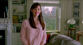 Movie still from “Nine Lives” (2016), directed by Barry Sonnenfeld – A woman standing in front of a window in a living room; Medium shot, Over the shoulder angle