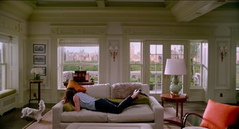 Movie still from “Nine Lives” (2016), directed by Barry Sonnenfeld – A person laying on a couch in a living room; Wide shot, High angle
