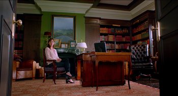 Movie still from “Nine Lives” (2016), directed by Barry Sonnenfeld – A woman sitting in front of a computer in a room; Wide shot, Low angle