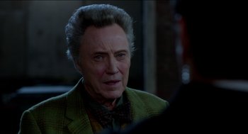 Movie still from “Nine Lives” (2016), directed by Barry Sonnenfeld – Christopher walken in a green jacket and a bow tie; Close Up shot, Over the shoulder angle