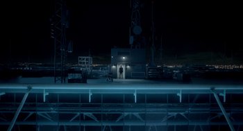 Movie still from “Nine Lives” (2016), directed by Barry Sonnenfeld – A man standing in the dark in front of a building at night; Extreme Wide shot, Low angle