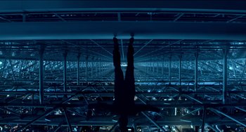 Movie still from “Nine Lives” (2016), directed by Barry Sonnenfeld – A person hanging upside down in a building; Wide shot, Overhead angle