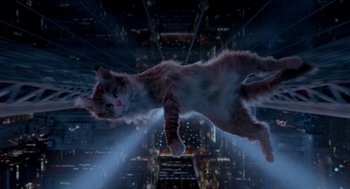 Movie still from “Nine Lives” (2016), directed by Barry Sonnenfeld – A cat flying through the air over a city at night; Wide shot, Overhead angle