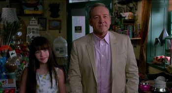 Movie still from “Nine Lives” (2016), directed by Barry Sonnenfeld – A man and a girl standing next to each other in a room; Medium shot, Over the shoulder angle