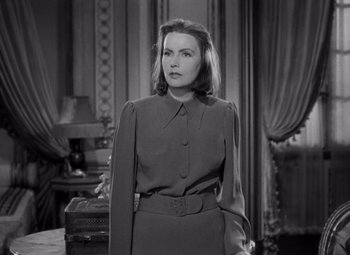 Movie still from “Ninotchka” (1939), directed by Ernst Lubitsch – A black and white photo of a woman in a suit; Medium shot, Low angle