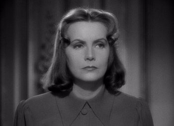 Movie still from “Ninotchka” (1939), directed by Ernst Lubitsch – An old photo of an older woman with long dark hair; Close Up shot, Over the shoulder angle