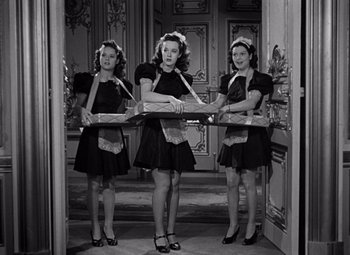 Movie still from “Ninotchka” (1939), directed by Ernst Lubitsch – A group of three young women in black dresses; Medium shot, Low angle