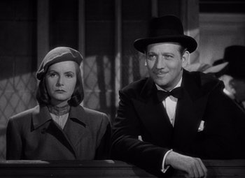Movie still from “Ninotchka” (1939), directed by Ernst Lubitsch – A man and a woman sitting next to each other; Medium shot, Low angle
