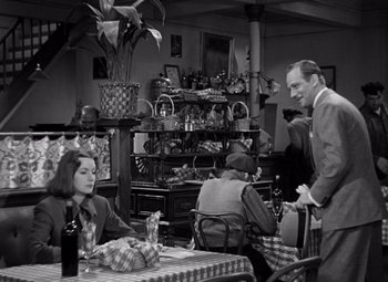 Movie still from “Ninotchka” (1939), directed by Ernst Lubitsch – An old photo of people sitting at a table in a restaurant; Medium shot, Over the shoulder angle