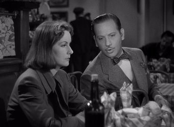 Movie still from “Ninotchka” (1939), directed by Ernst Lubitsch – A man and a woman sitting at a dinner table; Close Up shot, Over the shoulder angle