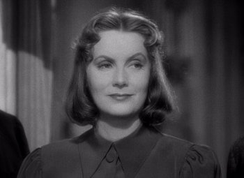 Movie still from “Ninotchka” (1939), directed by Ernst Lubitsch – An old photo of a woman in a black dress; Close Up shot, High angle