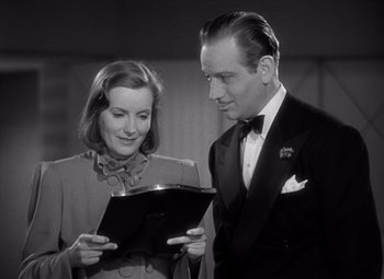 Movie still from “Ninotchka” (1939), directed by Ernst Lubitsch – A man and a woman looking at a piece of paper; Medium shot, Low angle