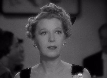 Movie still from “Ninotchka” (1939), directed by Ernst Lubitsch – An old photo of a woman in a black dress; Close Up shot, Low angle