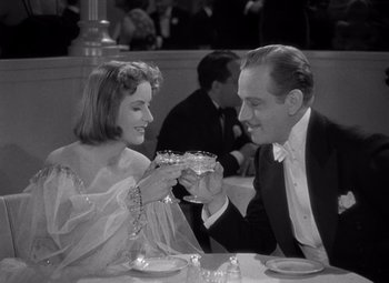 Movie still from “Ninotchka” (1939), directed by Ernst Lubitsch – A man and a woman sitting at a dinner table; Medium shot, Low angle