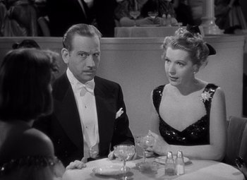 Movie still from “Ninotchka” (1939), directed by Ernst Lubitsch – A man and a woman sitting at a dinner table; Medium shot, Over the shoulder angle