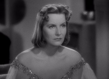 Movie still from “Ninotchka” (1939), directed by Ernst Lubitsch – A black - and - white photo of a woman in a dress; Close Up shot, Over the shoulder angle