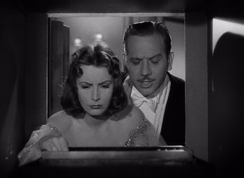 Movie still from “Ninotchka” (1939), directed by Ernst Lubitsch – A man and a woman looking in a mirror; Medium shot, Low angle