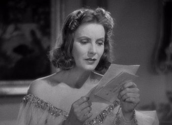 Movie still from “Ninotchka” (1939), directed by Ernst Lubitsch – A woman holding a piece of paper in her hands; Close Up shot, Low angle