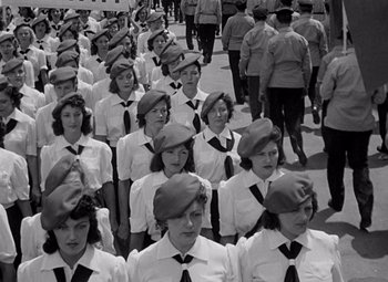 Movie still from “Ninotchka” (1939), directed by Ernst Lubitsch – Black and white photograph of a group of women in uniform; Medium shot, High angle