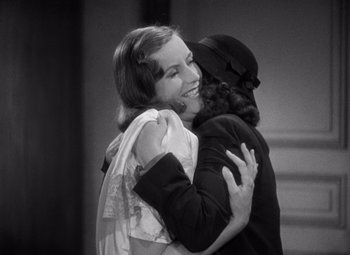 Movie still from “Ninotchka” (1939), directed by Ernst Lubitsch – Two women embracing each other in a black and white photo; Medium shot, High angle